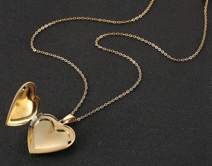 Gold heart locket necklace open showing photo compartment